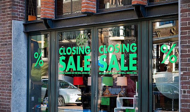 Closing sale signs in window Amsterdam, The Netherlands - February 2, 2013: The window of a store (DOM in the Spuistraat) closing down, displaying "closing sale" signs in the window in Amsterdam, the Netherlands. closing down sale stock pictures, royalty-free photos & images