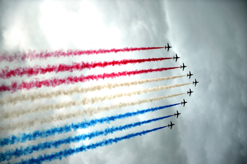 London, England - July 27, 2012: The Royal Airforce Red Arrows squadron flying in formation over London at the 2012 Olympics