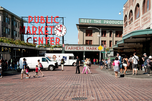 Seattle, USA - July 23, 2013: People crossing the street in front of the famous PIke Place Market in the early morning.