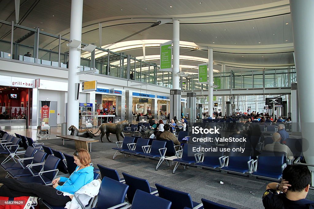 Waiting at the Gate Toronto, A!anada - March 1, 2012: A waiting area and passengers waiting at the Toronto Pearson Airport Airplane Stock Photo