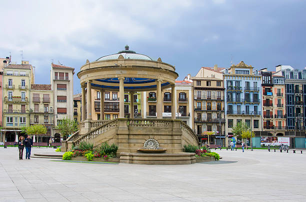 Pamplona, Spain - October 18, 2012: An unidentified couple strolling through the Castle Square in Pamplona  beside the Temple ,Spain