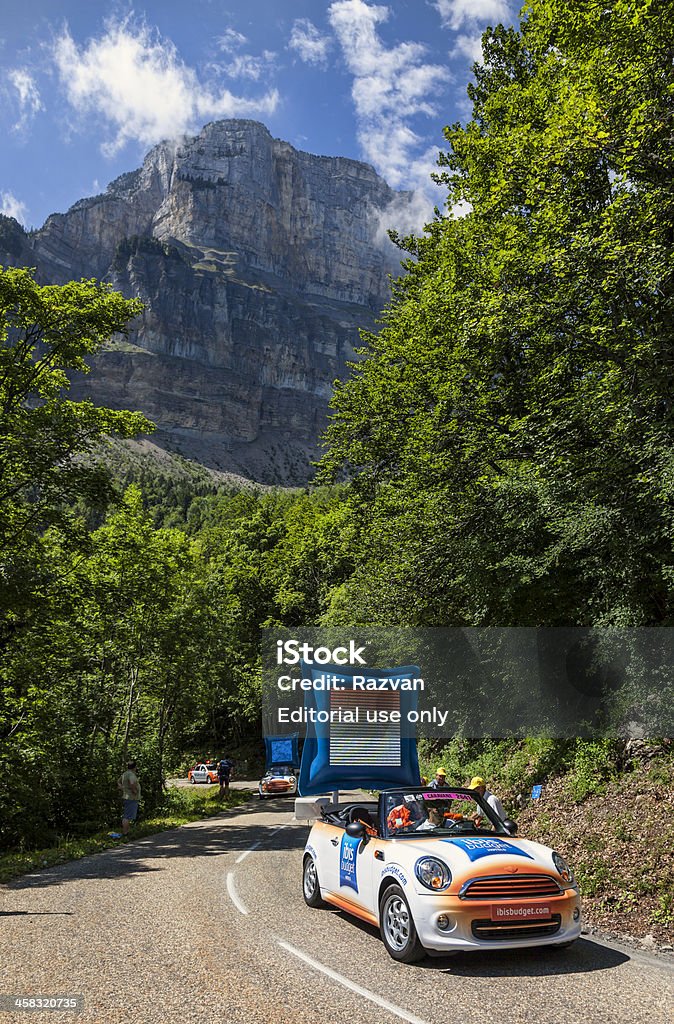 Ibis Budget Hotels Car During Le Tour de France La Palud,France-July 13th, 2012:The car of Ibis Budget Hotels during the passing of the Publicity Caravan on the category I climbing route to mountain pass Ganier, in the 12 stage of the 2012 edition of Le Tour de France, the biggest cycling race in the world. Before the appearance of the cyclists there is a caravan of advertising cars of the all sponsors of the competition.Ibis Budget Hotel is an international chain of cheap hotels. Advertisement Stock Photo