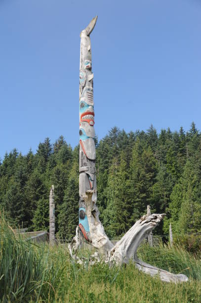 Haida Totem Pole Skidegate,British Columbia, Canada - August 18, 2012: A traditional totem pole stands in front of the Haida Heritage Centre in Skidegate haida gwaii totem poles stock pictures, royalty-free photos & images