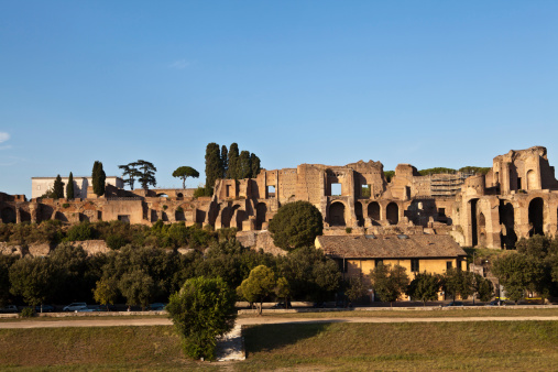 Rome, Italy - August 19, 2013: view on Domus Augustana on Palatine Hill in Rome - looking over Circus Maximus - cars and people passing an the road