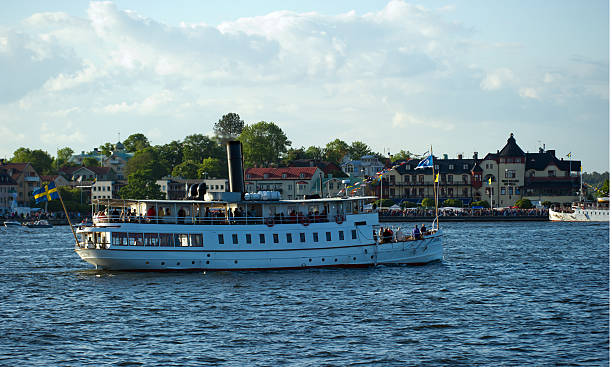 S/S Mariefred approach Vaxholm Vaxholm, Sweden - June 13, 2012: Steamship Mariefred approach Vaxholm where the passengers will celebrate the day of these old ships which were, and still is, trafficking the Stockholm archipelago. mariefred stock pictures, royalty-free photos & images
