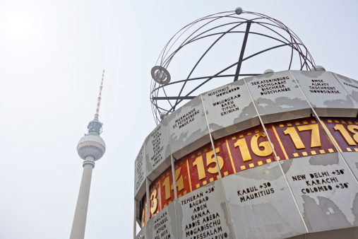 Berlin, Germany - January 28, 2013: The World Clock ( Weltzeituhr) at Alexanderplatz, Berlin. The television tower (fernsehturm) at background, this is the 368 meters high and is the tallest building in Germany.