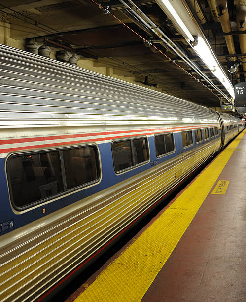 Amtrak at Penn Station New York, United States - June 8, 2013: Amtrak Train No. 155, New York (Penn Station) to Washington (Union Station) waits to depart from Track 15. The train will cover the 226 miles in 3 hours 20 minutes, hauled by an electric locomotive.. Amtrak stock pictures, royalty-free photos & images