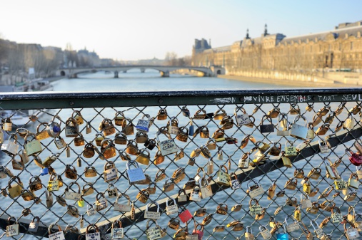 Paris, France - February 10, 2012: Love Padlocks, or love locks, attached to the Pont des Arts on the river Seine as a symbol of couples' everlasting love.