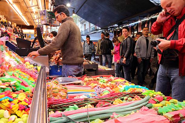 Barcelona, Spain - November 6, 2012: People visit Boqueria market on November 6, 2012 in Barcelona, Spain. Tripadvisor says it is best shopping destination in Barcelona, the most visited city in Spain.