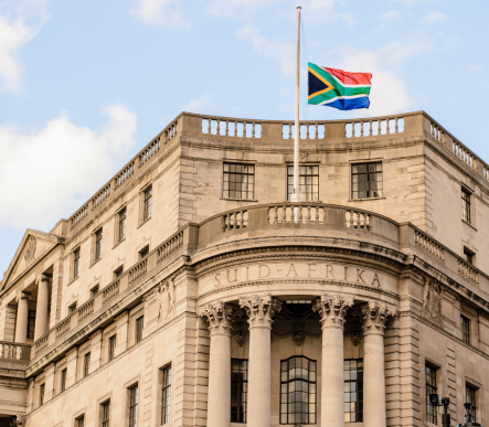 London, England - August 22, 2012: The South African Embassy on The Strand in London flying its flag at half-mast during a period of national mourning. A period of mourning was declared to honor in particular those people who had suffered violent deaths in Marikana, North West province earlier in the month.