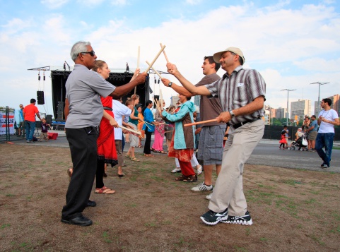 Ottawa, Canada - August 11, 2012: People playing Dandiya at the Festival of India in Ottawa, Ontario. Dandiya is an Indian dance where participants bang sticks together to music.
