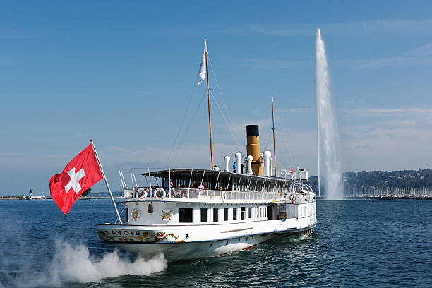 Geneva, Switzerland - September 22, 2011: steamboat SAVOIE leaving Geneva harbor, famous Jet dA'eau in the back