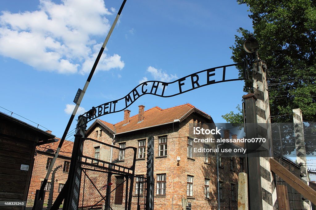 Entrance gate to Auschwitz concentration camp Oswiecim, Poland - July 23, 2011: The main entrance gate to Auschwitz concentration camp, Poland. It was the biggest nazi concentration camp in Europe during World War II Arbeit macht frei Stock Photo