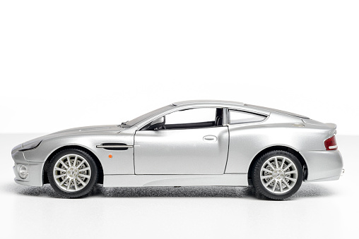 Kampen, The Netherlands - July 3, 2013: Studio shot of a BBurago Aston Martin Vanquish model car on a white background.