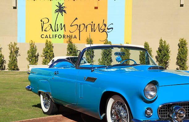 Palm Springs,United States- November 18,2012: Public square downtown Palm Springs with early model Robin Egg Blue Ford Thunderbird convertible.  Palm Springs was the place to be in the Mid 20th Century.