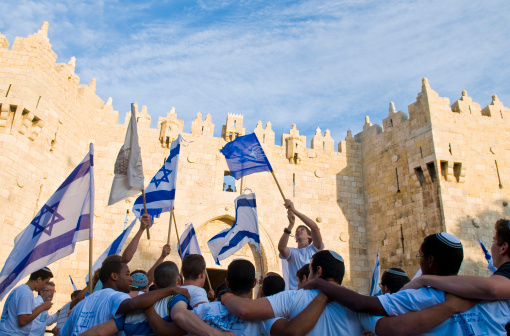 Jerusalem , Israel - May 20, 2012: Right wing Israeli men dance on Jerusalem day in front of Damascus gate before marching through the Arab quarter of Jerusalem old city, Jerusalem day marks the anniversary of Israel capturing the eastern part of the city during the 1967 Middle east war