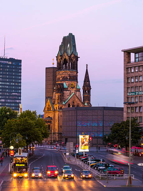 Kaiser Wilhelm Memorial Church, Berlin, Germany Berlin, Germany - August 8, 2006: Kaiser Wilhelm GedAchtniskirche at sunset, Berlin, Germany. The foreground of the image is lit up by the headlights of vehicles stopped at a junction. kaiser wilhelm memorial church stock pictures, royalty-free photos & images