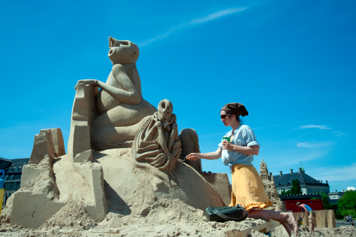 Copenhagen, Denmark - May 28, 2012: Lena Tempich from Germany working on her sand sculpture in the annual Copenhagen Sand Sculpture Festival in the Copenhagen Harbour