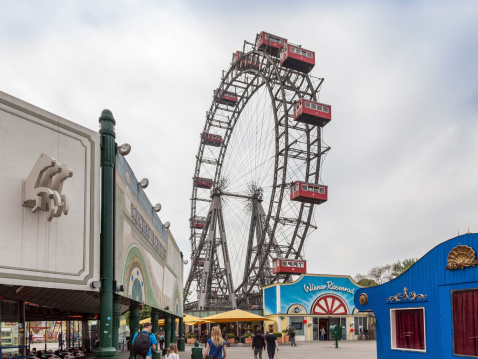 Vienna, Austria - April 29, 2013: People at the Prater Park, an amusement park in Vienna. The Ferris Wheel is one of the landmarks of Vienna.