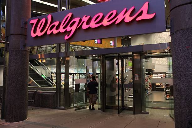 Walgreens pharmacy Boston, United States - June 9, 2013: Shopper enters Walgreens store on June 9, 2013 in Boston. Walgreens is the largest drug retail chain in the United States with 8,300 stores in 50 states. walgreens stock pictures, royalty-free photos & images