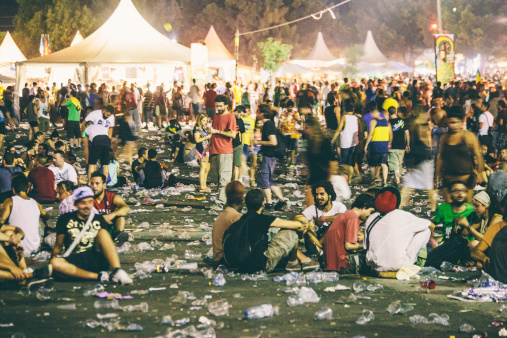 Benicassim, Spain - August 25, 2013: Festival crowd sitting on the ground in front of the main stage after Jamaican reggae/dancehall artist Damian Marley was performing. Rototom Sunsplash is biggest reggae festival in Europe and been around for 20 years.