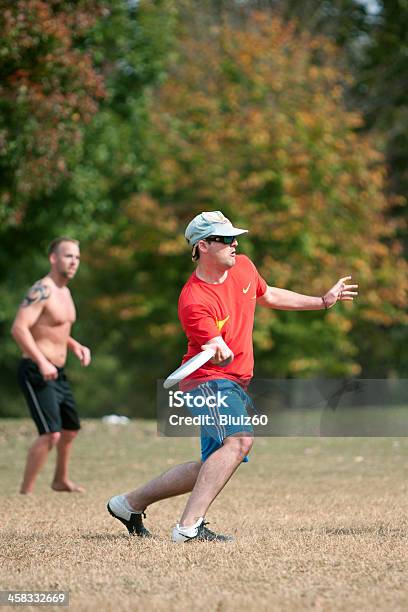 Young Male Plays Ultimate Frisbee In Park Stock Photo - Download Image Now - Autumn, Exercising, Fun