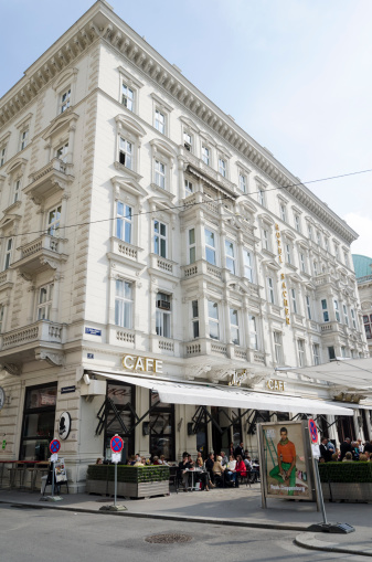 Vienna, Austria - April 20th, 2012: Famous five-star Hotel Sacher with Cafe Mozart(serving original Sacher chocolate cake with apricot filling), people sitting in front.