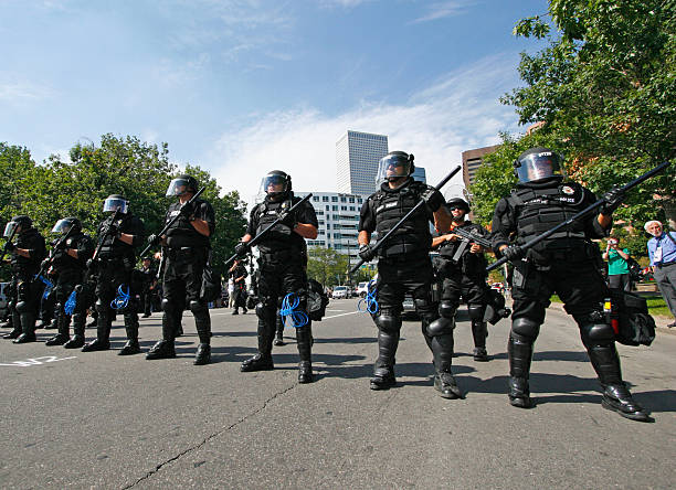 Riot Police Denver, USA - August 24, 2008: A line of riot police guard a street from protesters in downtown Denver during the 2008 Democratic National Convention. riot police usa stock pictures, royalty-free photos & images