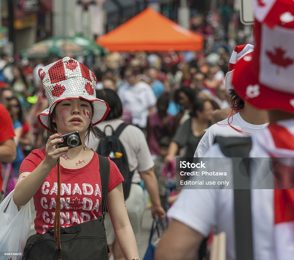 Asian Girl with Camera on Canada Day Ottawa, Canada - July 1, 2013: An Asian girl trying to catch a photo during Canada Day in downtown Ottawa, Ontario. Canada Day Stock Photo