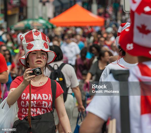Asian Girl With Camera On Canada Day Stock Photo - Download Image Now - Canada Day, 2013, Adult