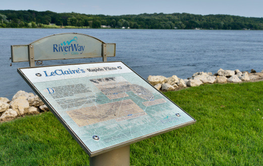 LeClaire, Iowa, USA - July 8, 2013: The Mississippi River in LeClaire, Iowa with a sign explaining the historical significance of the area.