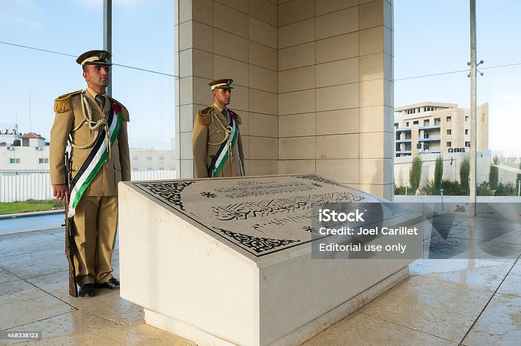 Yasser Arafat's Grave in Ramallah Ramallah, West Bank, Palestinian Territories - October 25, 2010:  Two guards stand over the tomb of Yasser Arafat at the Palestinian Authority Presidential compound in Ramallah. Arafat was for decades the symbol of the Palestinian national movement. He died in 2004 while President of the Palestinian Authority. Yasser Arafat - Political Figure Stock Photo