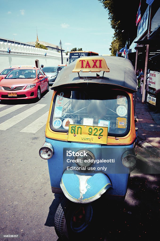 tuk-tuk and taxi on the road in Bangkok Bangkok, Thailand - August 11 2012: tuk tuk and taxis on the road next to Grand Palace in Bangkok Asia Stock Photo