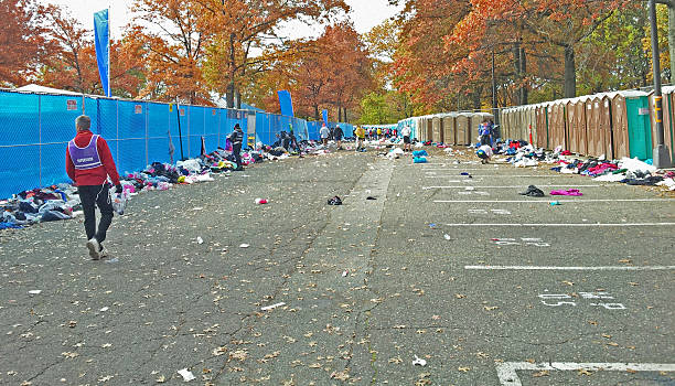 New Yourk Marathon, November, 3, 2013: charity donations New York City, USA - November 3, 2013: New Yourk Marathon charity donations. It was a cold and windy day when New York Marathon started, and most runners waited for a start in warm clothing. Just before the start they took off their warm clothes and left them at the corrals. All this clothes will be sorted and donated for charity. new york marathon photos stock pictures, royalty-free photos & images