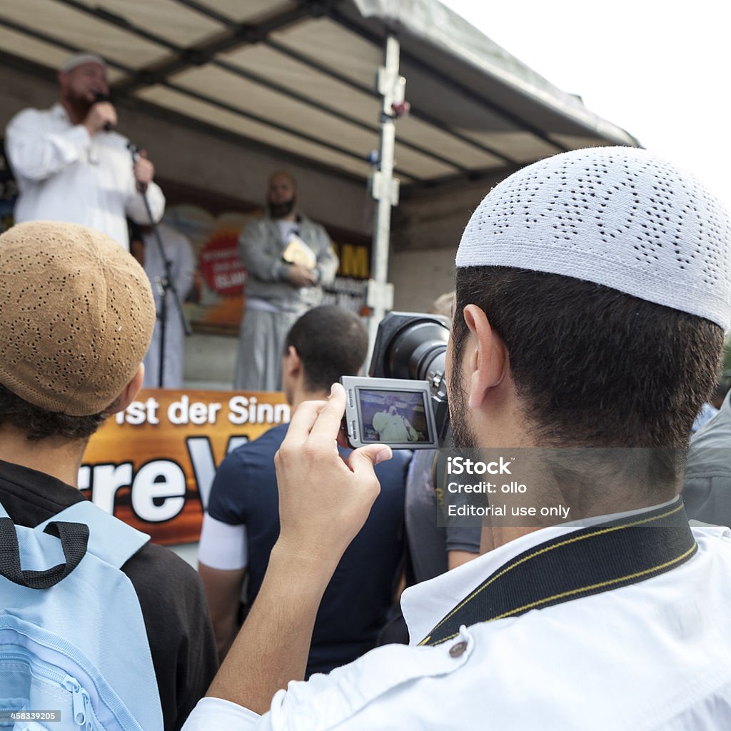 Islamic Peace Congress, Frankfurt Frankfurt, Germany - September 7, 2013: Participants of the so called Islamischer Friedenskongress (Islamic peace conference) in the city center of Frankfurt, Germany - taking photos of the preacher. The demonstration was organized by Salafist Moslems and German Islamic preacher Pierre Vogel (in the background) Adult Stock Photo