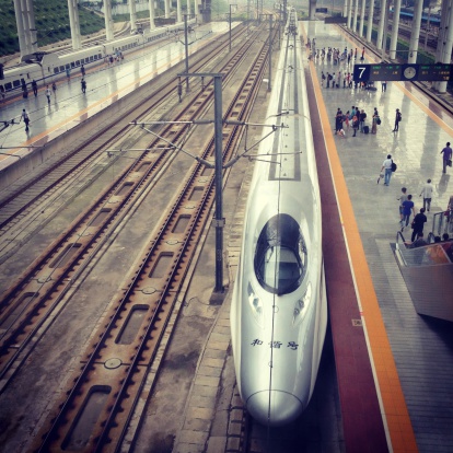 Shanghai, A!hina - June 30, 2013: Top view of CRH Train of China.  The train arrived to the station. Passengers waiting for train. Photo taken from Shanghai City, China. Photo taken with Apple iPhone.