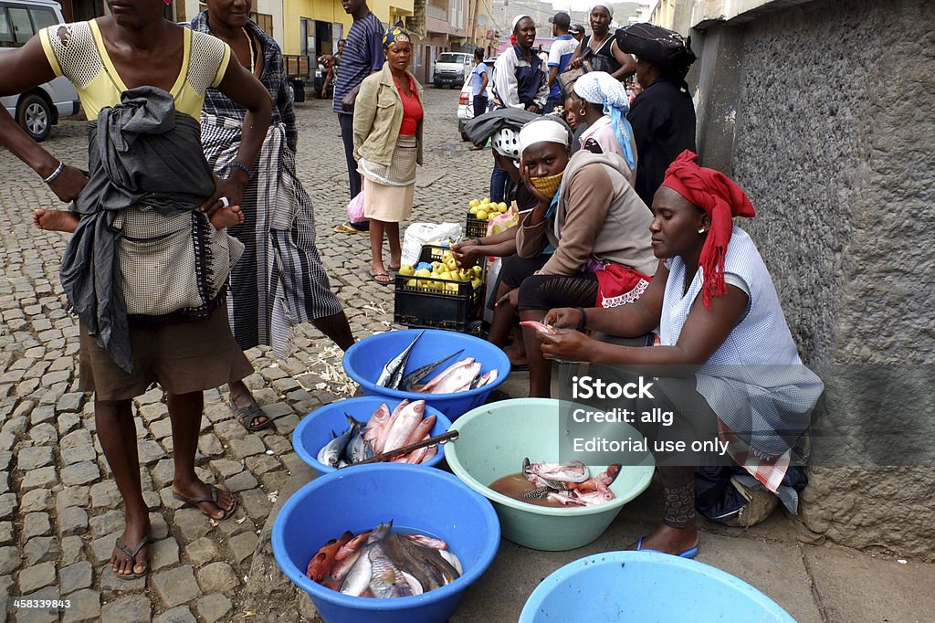 Fish vendor. Assomada, Cape Verde - December 5, 2012: an African fish vendor is waiting for buyers in the street. Adult Stock Photo