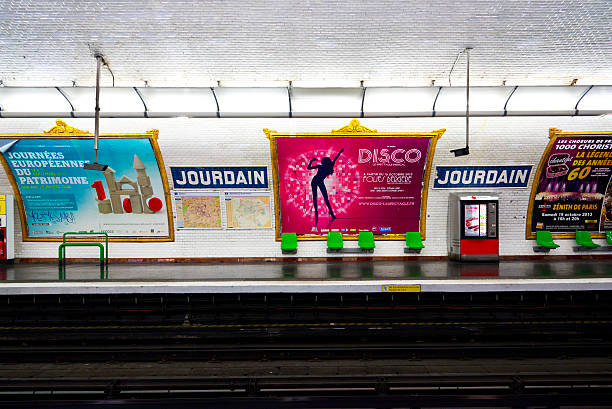 Paris Metro Station Paris, France - September 1, 2013: Empty platform of the subway station Jourdain with large golden framed advertising bills on the white tunnel walls. A few green seats and a snack vending machine are placed on the platform. window seat vehicle stock pictures, royalty-free photos & images