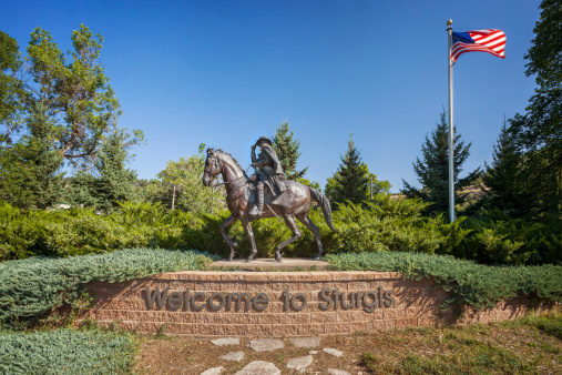 Sturgis, South Dakota, United States aa August 18, 2012: Sturgis welcome sign, statue of General Samuel D. Sturgis and American flag on August 18, 2012.