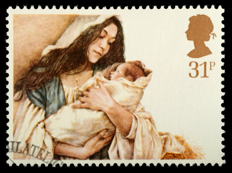 Exeter, United Kingdom - October 16, 2011: British Used Christmas Postage Stamp showing the Virgin Mary and Baby Jesus nativity scene, printed and issued in 1984