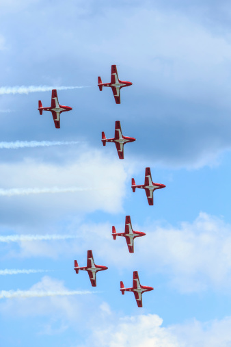 Bagotville, Quebec, Canada  - June 22, 2013: The Bagotville Airshow is a 2 days airshow where the Bagotville Airport opens to the public with a variety of aerial performers as well as aircraft and vehicles on display. This image shows The Canadian Snowbirds aerial demonstration team showing their piloting skills.