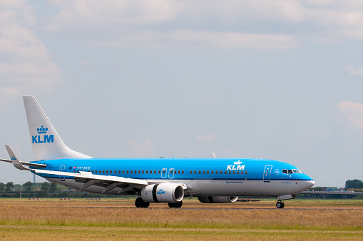 Amsterdam, The Netherlands - June 24, 2011: KLM airlines Boeing 737 plane landing at Schiphol airport in The Netherlands.