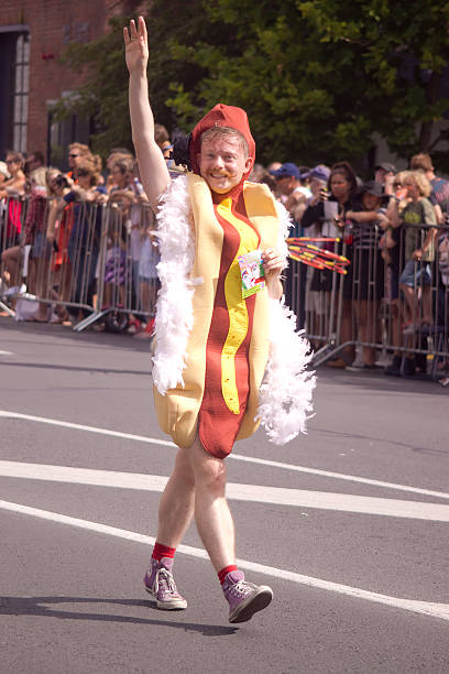 auckland pride parade: hot dog mann - wearing hot dog costume stock-fotos und bilder