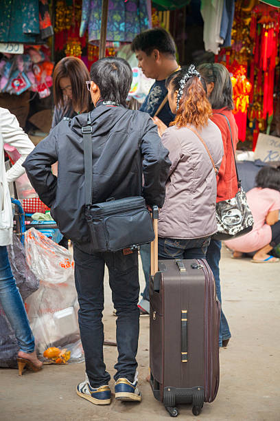 Tachileik, Myanmar - December 13, 2011: People can be seen on the street buying and selling goods at a street market. The town is a popular destination for travellers making a visa run from Thailand, and Thai people looking for cheap goods from Myanmar.