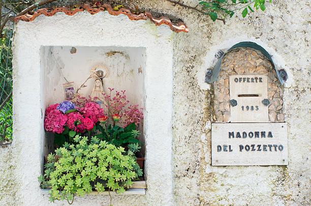 Santa Maria del Giudice, Italy - July 5, 2013: One of the central (albeit small) streets of the Santa Maria del Giudice village in the province of Lucca is decorated with this votive statue (\