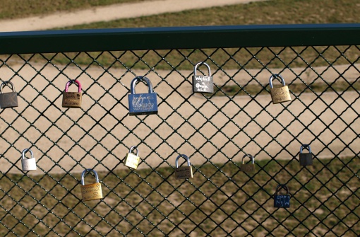 Zamosc, Poland - September 08, 2013: A lot of closed padlock in a pederestrian bridge in Zamosc. Padlock were locked for lovers as sign their love. Photo was made on September 09, 2013 in Zamosc, Poland