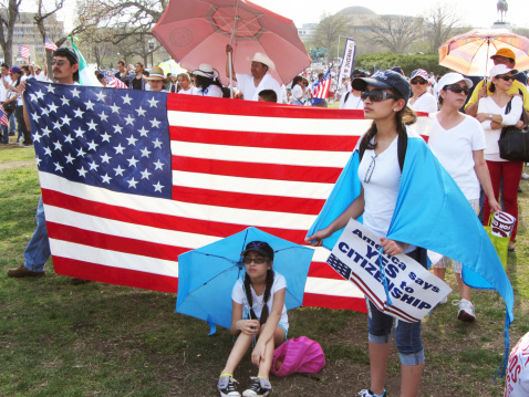 Washington D.C., USA-April 10, 2013:  Latino protesters rally at the U.S. Capitol building in Washington D.C. in order to reform immigration laws in the United States.  Barack Obama was elected with the Latino vote and promised immigration reform.