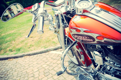 ForlA, Italy - July 13, 2013: Detail of Harley Davidson logo in a tank of motorcycle. Harley Davidson is an American motorcycle manufacturer founded in Milwaukee ,Wisconsin USA. No people.