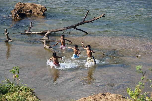 Khanh Hoa, Viet Nam - February 5, 2013: Chidren playing, bathe in the river, this is warning about  children's drowning  situation at countryside, Khanh Hoa, February 5, 2013