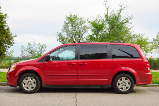 Hamilton, Canada - September 15, 2013: Red colored, generation V, Dodge Grand Caravan parked on the street.